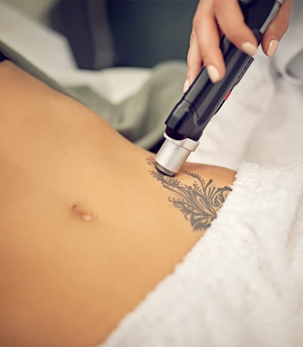 A Dermatologist Inspecting A Tattoo On A Woman's Abdomen